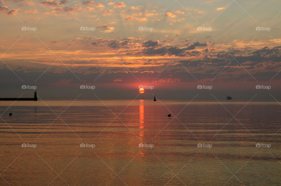 Sunrise at sea with dramatic sky