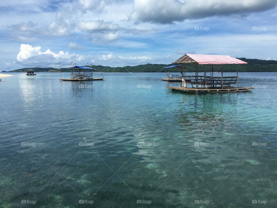 From the view deck of our own floating cottage, we glance at our neighbouring cabanas adrift the calm, crystal waters of Suguicay Island Resort.  