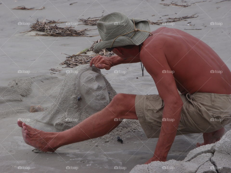 Artist and sand sculpture