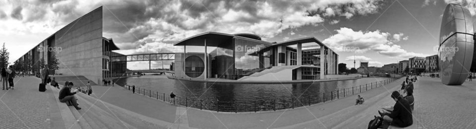 sitting on stairs. people relaxing and watching at stairs close to river spree in berlin