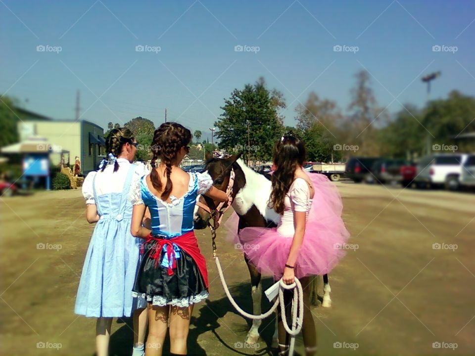 Girls and their horse dressed in tutu for Halloween