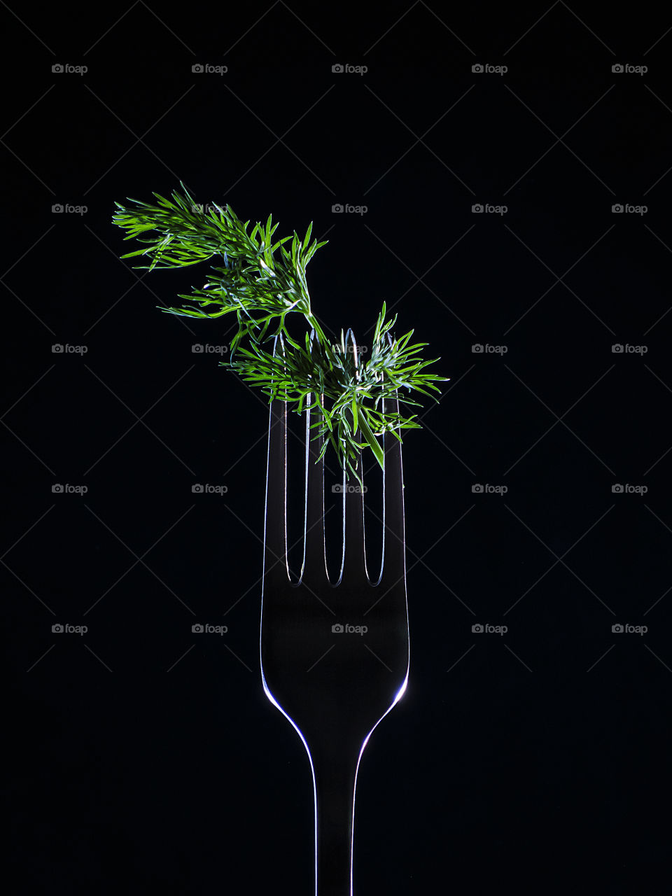 Green dill caught on the fork