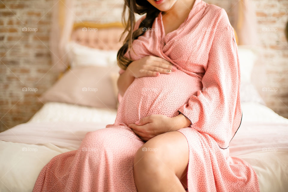 Pregnant woman touching her belly