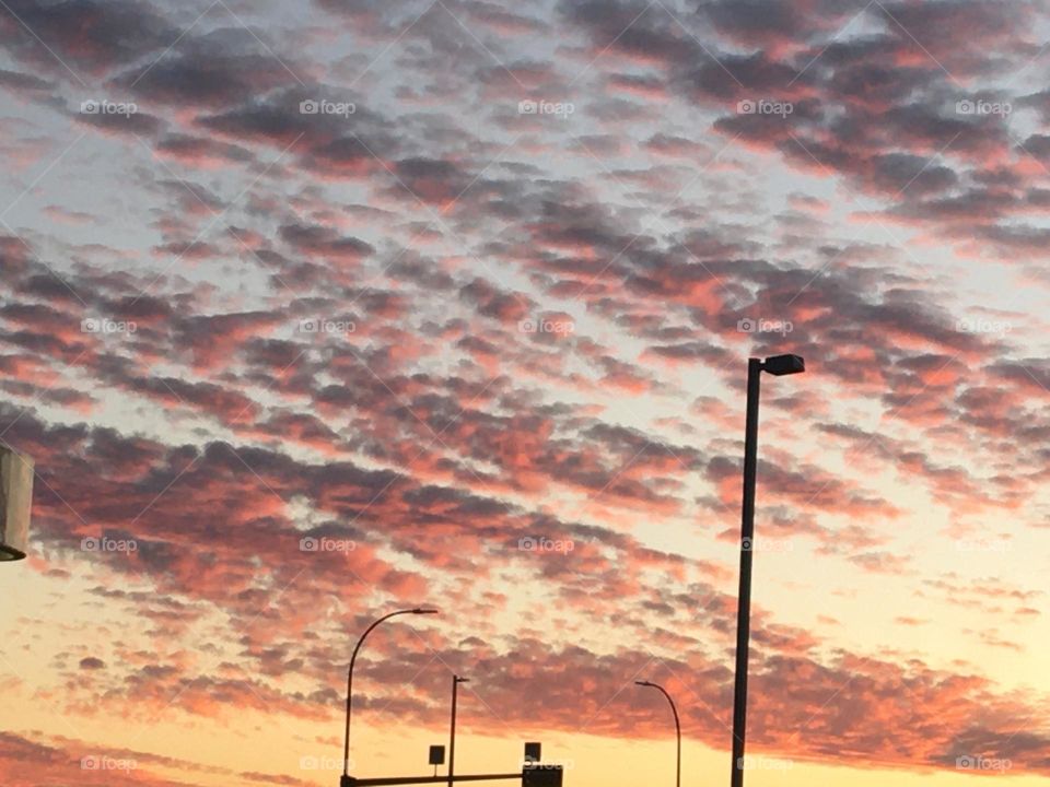 Another beautiful orange, and yellow colorful sunrise, with purple bubble lined clouds promises a gorgeous day