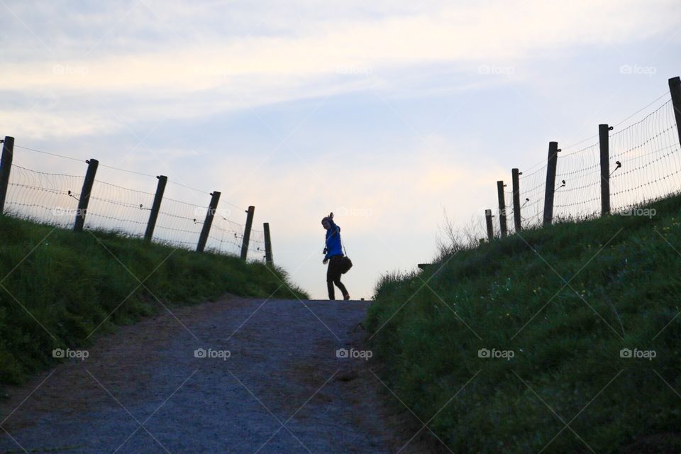 Girl waving bye bye. Waving bye bye from the hill