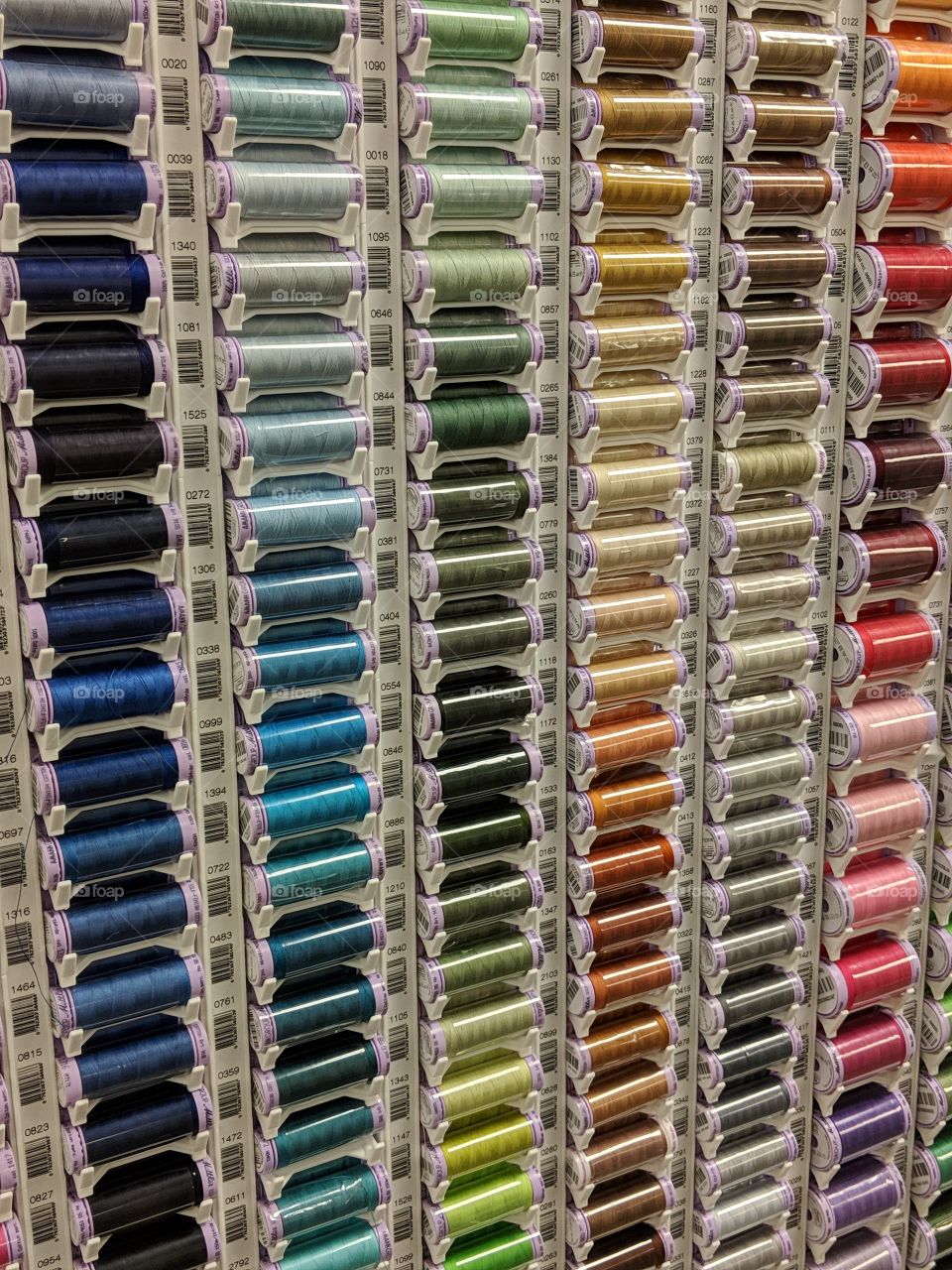 Colourful spools of thread. Ombre colours Sewing supplies. Tailoring supplies Dressmaking .