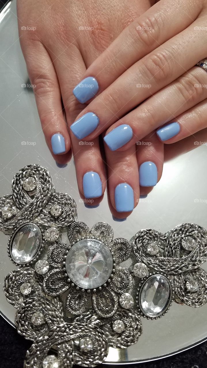 Gel fingernails polished blue