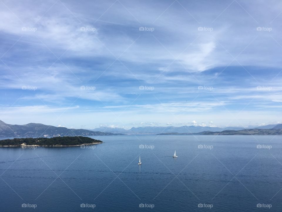 Boats crossing between Vidos Island and mainland Greece