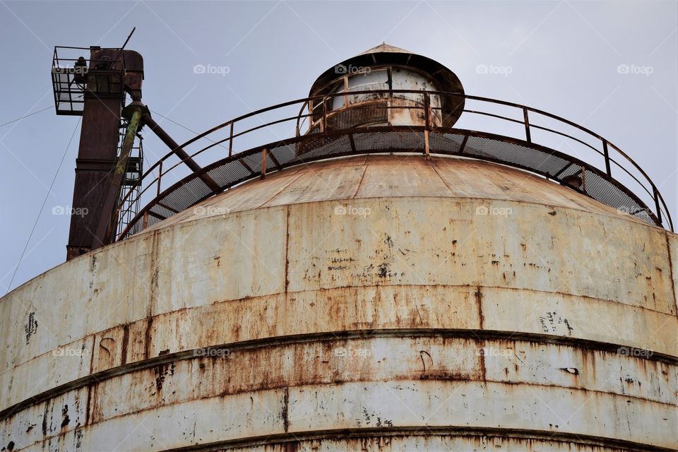 A rusted silo sits abandoned after years of neglect