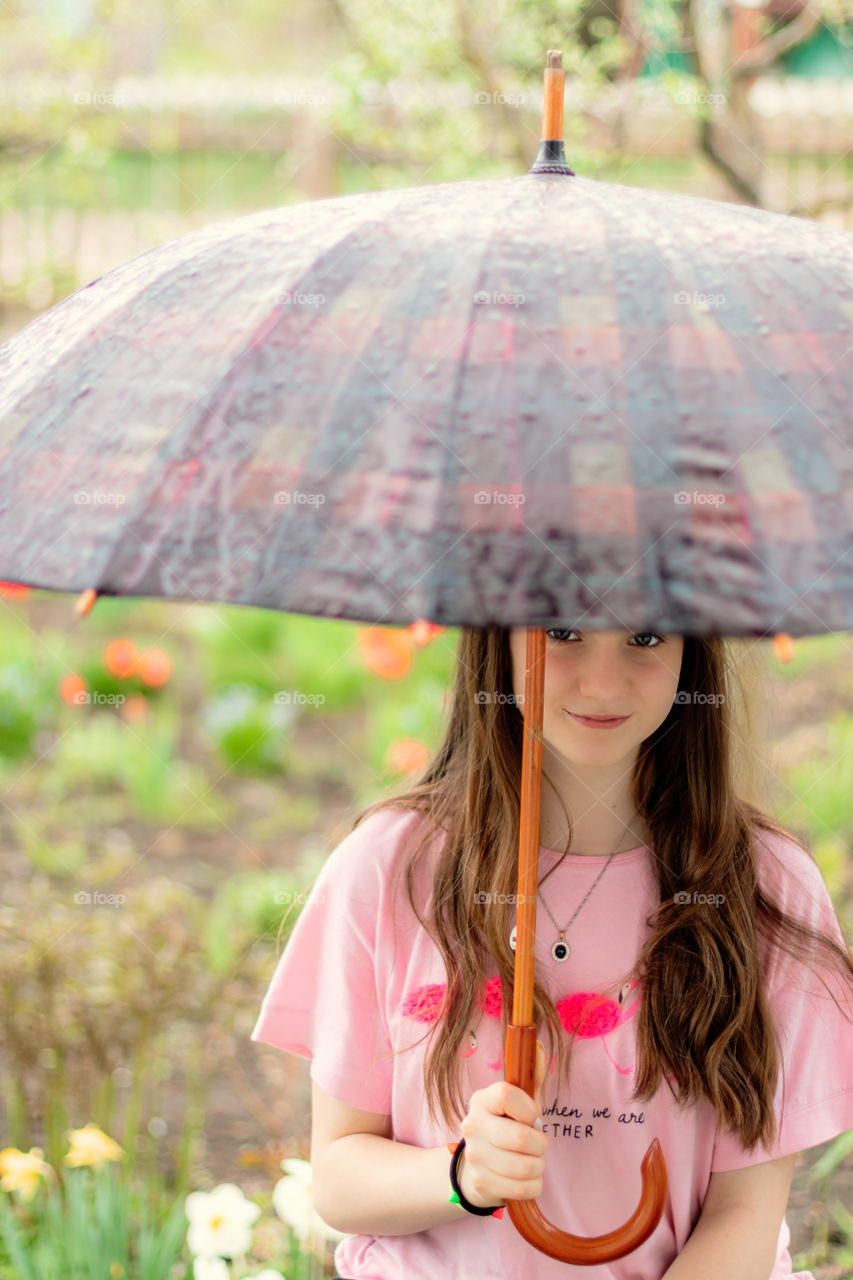 Portrait of girl with umbrella. Rainy day.