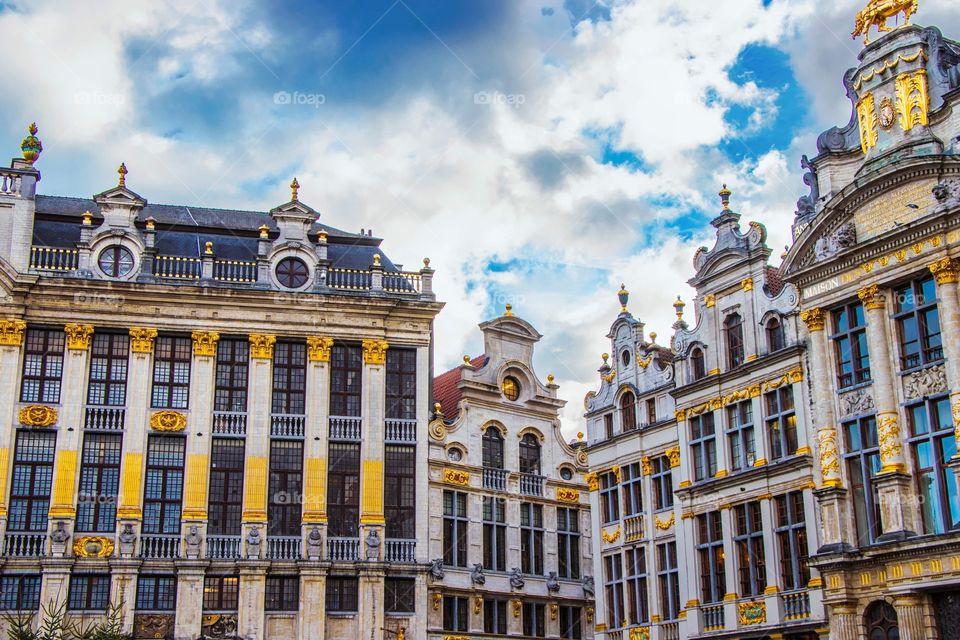 The rectangular shapes of the buildings of Brussels and a bright blue sky.