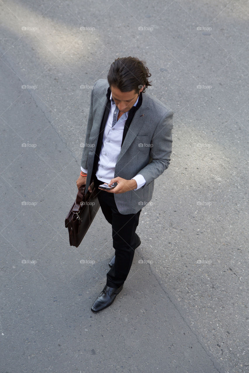 Young man executive suit. Urban street city scene businessman