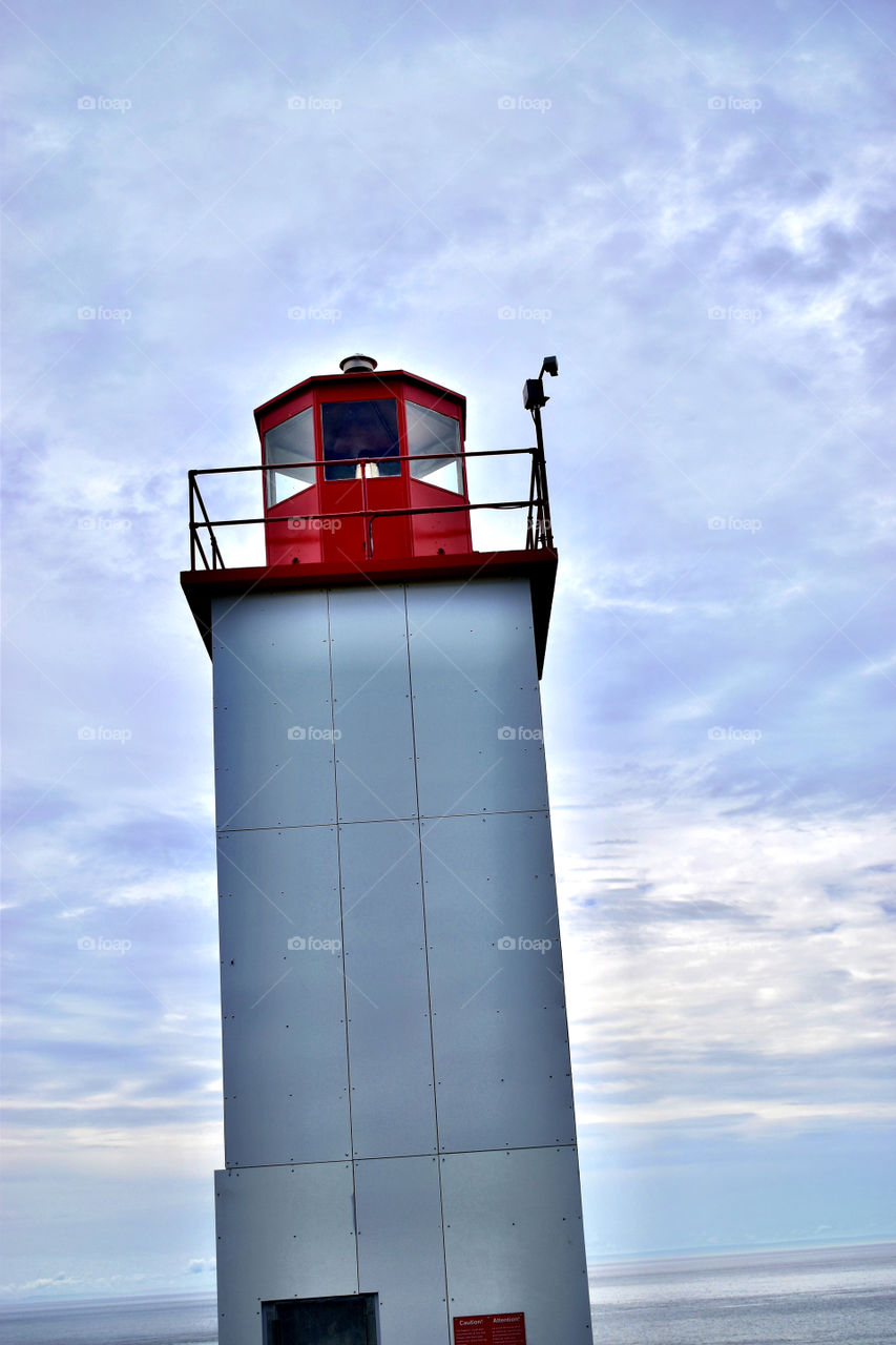 A lighthouse by the ocean on a summer day in New Brunswick Canada on a summer vacation 
