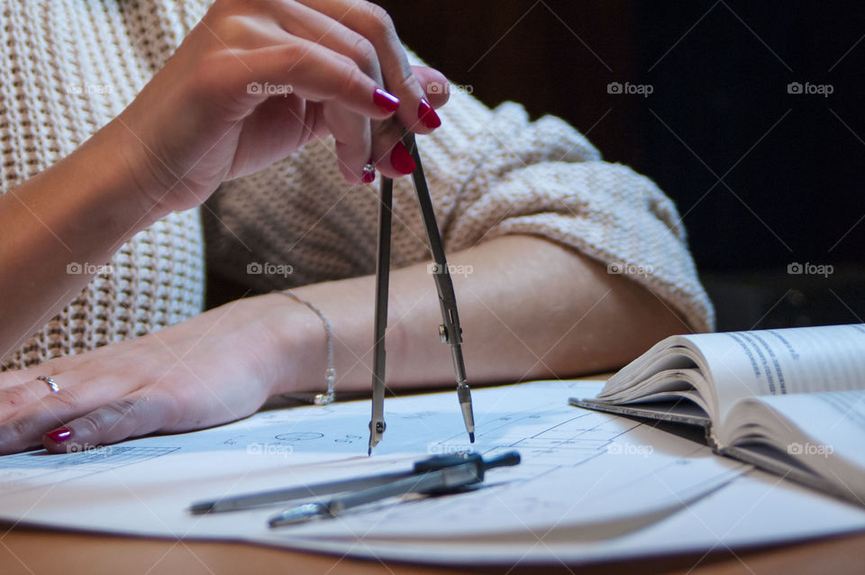 Girl draws a drawing compass