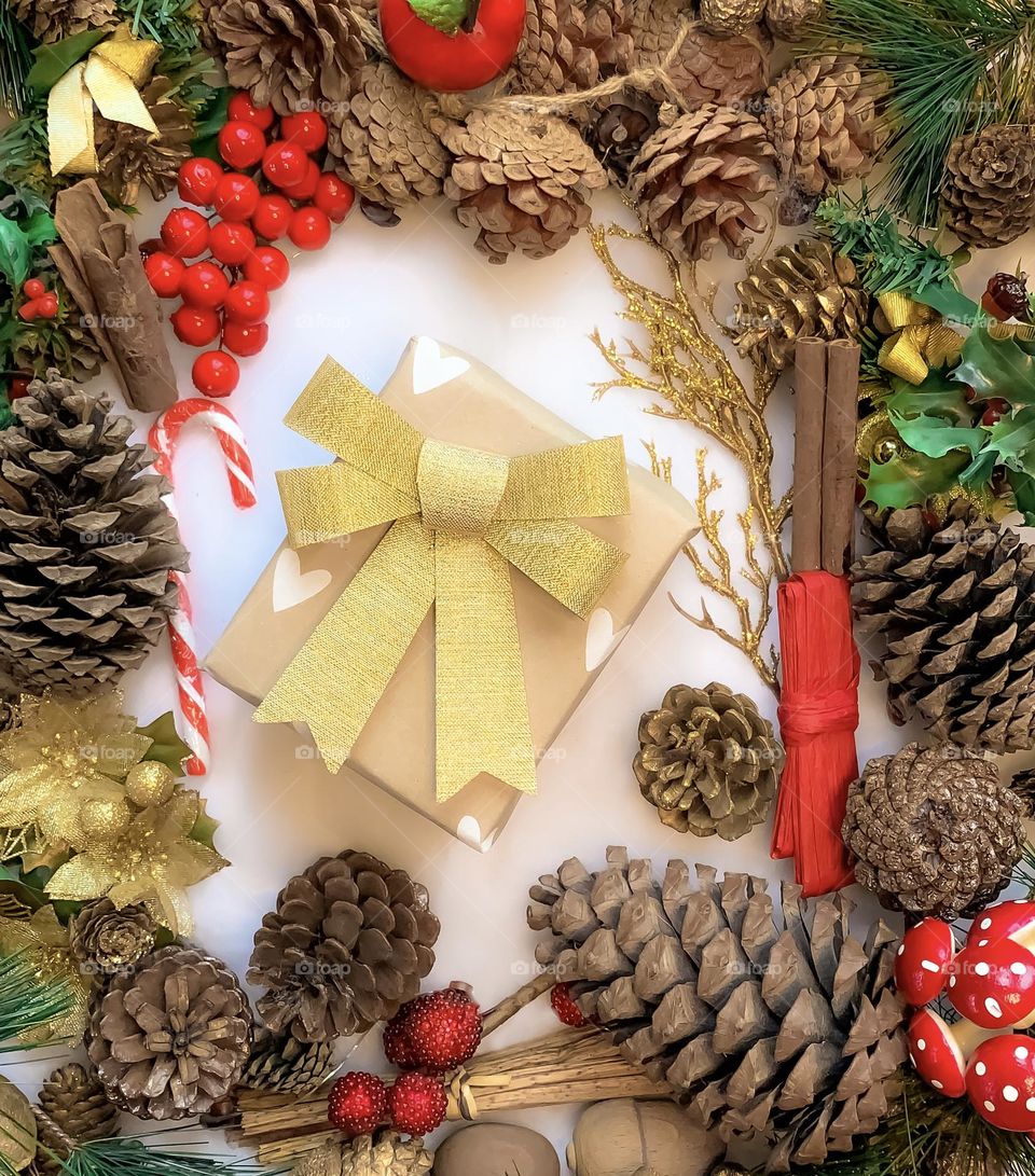 Festive flat lay of decorations centred around a wrapped present