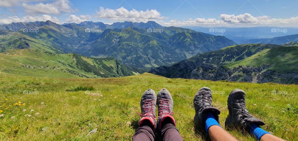 Couple in hiking boots enjoying the view over mountains