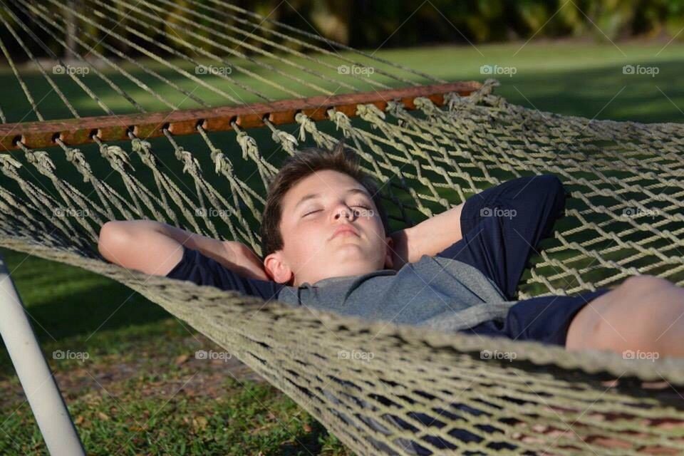 Hammock boy . Relaxing on a beautiful day 