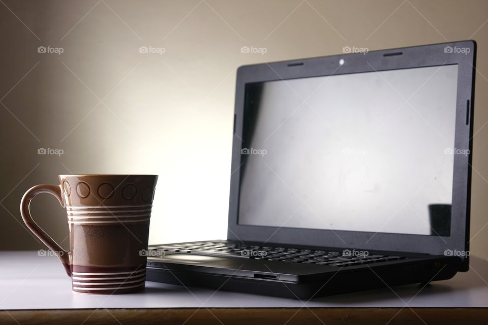 coffee mug and laptop computer