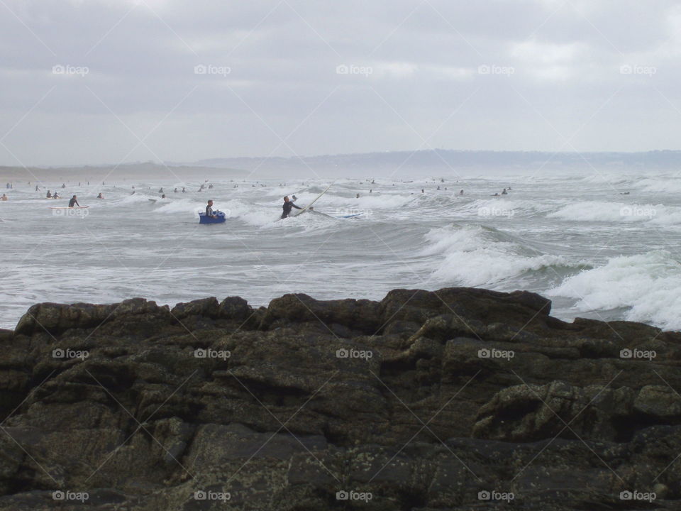 Sea full of surfers