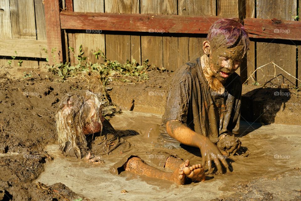 Boys Playing In Mud