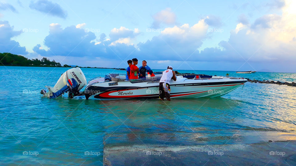 Speed Boat, good weather, blue sky, beautiful sea, children is going with their father to have some fun travelling by a new Speed Boat.