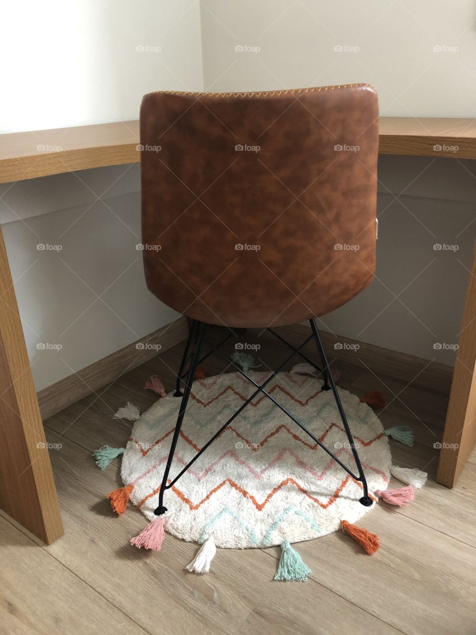 Desk, chair and a colored round rug