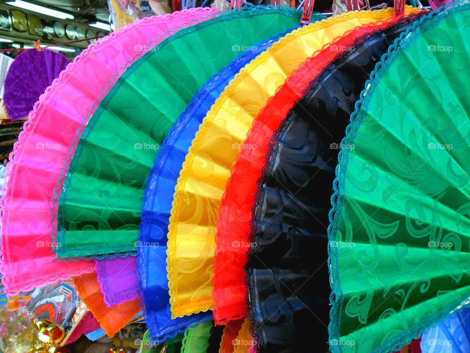 colored fans sold by a street vendor