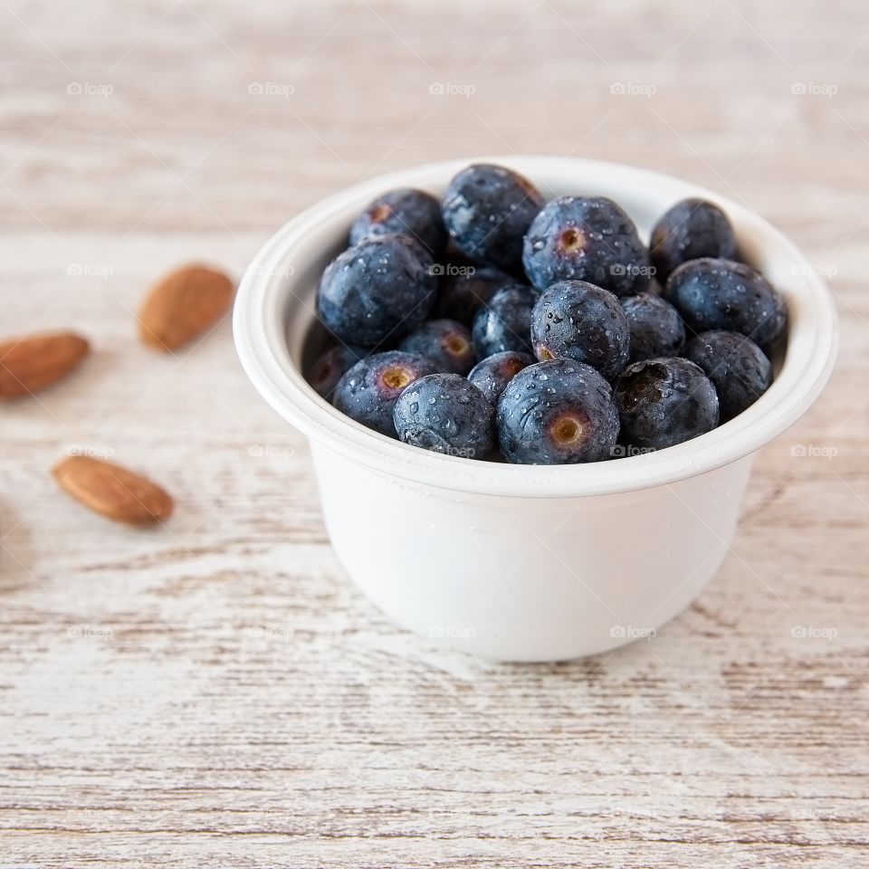 Bowl of blueberries on a wooden table 