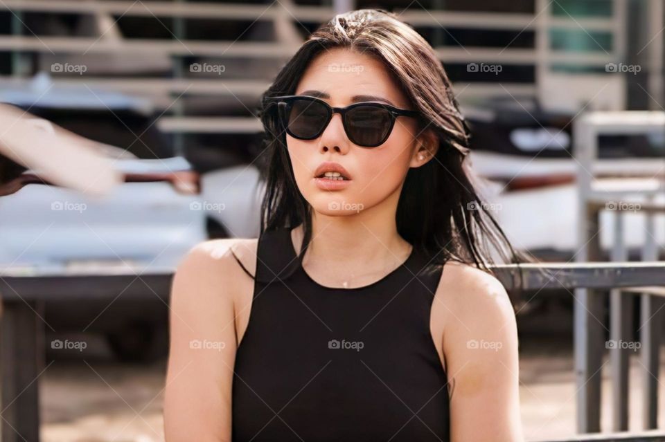 Portrait of a young woman wearing sunglasses