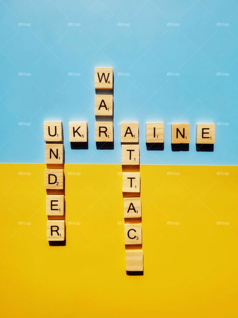 Top view of cube beads with words Support Ukraine close up.  Creative idea of freedom.  Blue, yellow background