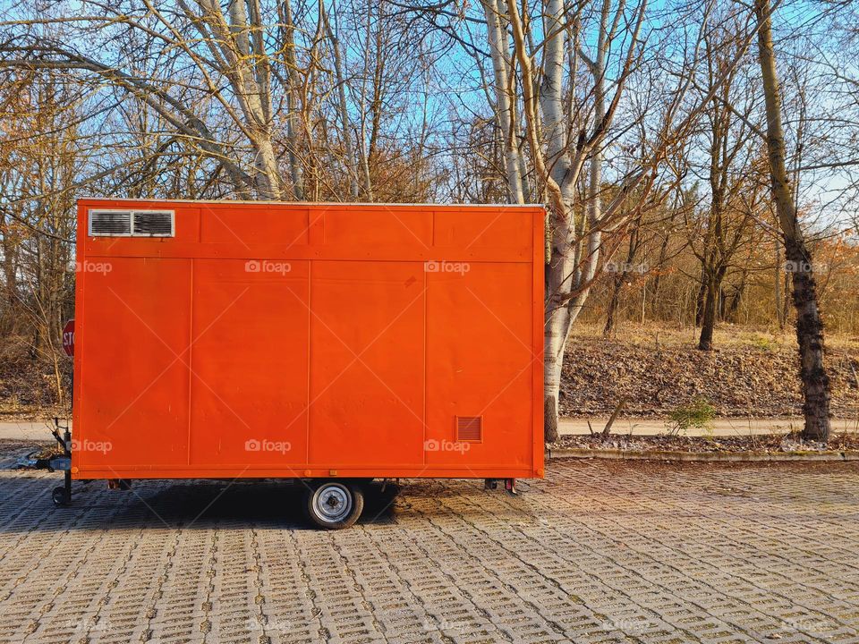 rectangular orange colored trailer parked