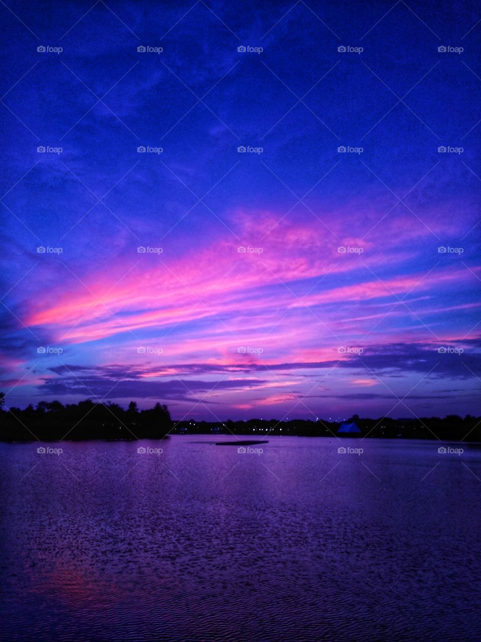 A gorgeous morning waterscape of purple, pink, and blue shades at Cranes Roost Park in Altamonte Springs, Florida.