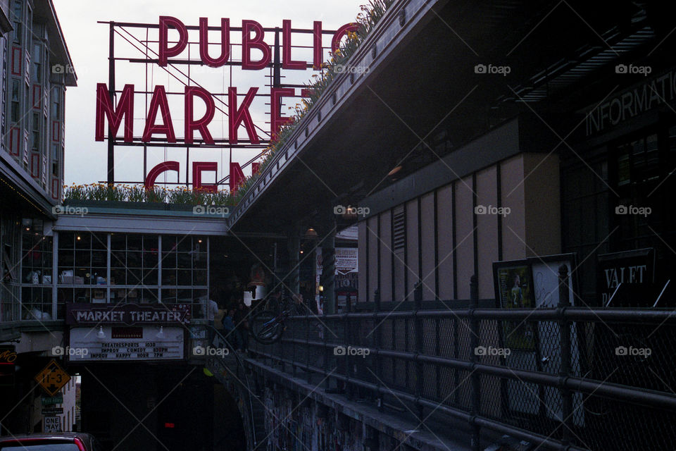 The view of the iconic public market center sign while going down the alley in Seattle