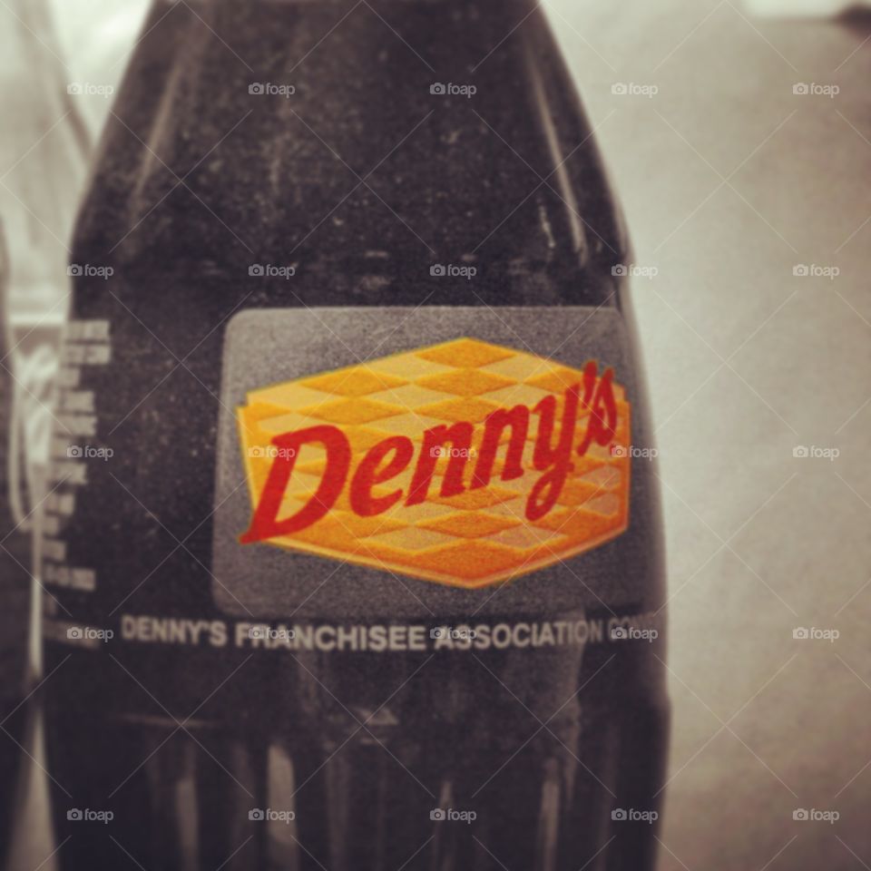 American Classic. A classic coke bottle with the Dennys logo on it. 