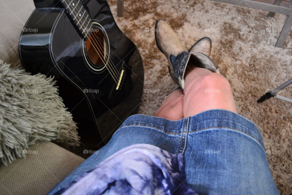 My point of view sitting in cowboy boots with guitar