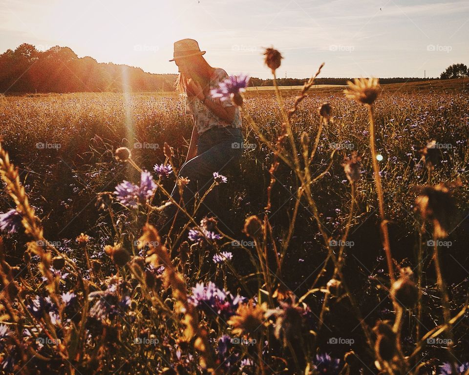 Woman walking in flower field