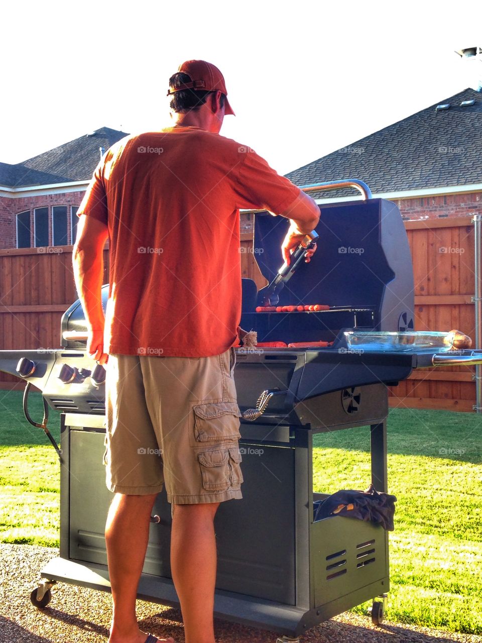 Ready, set, flip. Man cooking on a grill