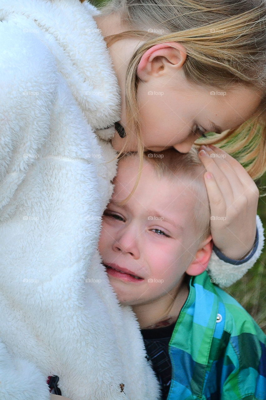 Sister cuddling her brother