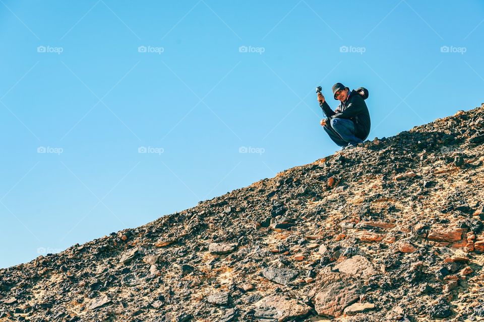 Trekking to the top of hill at Black Desert in Egypt 