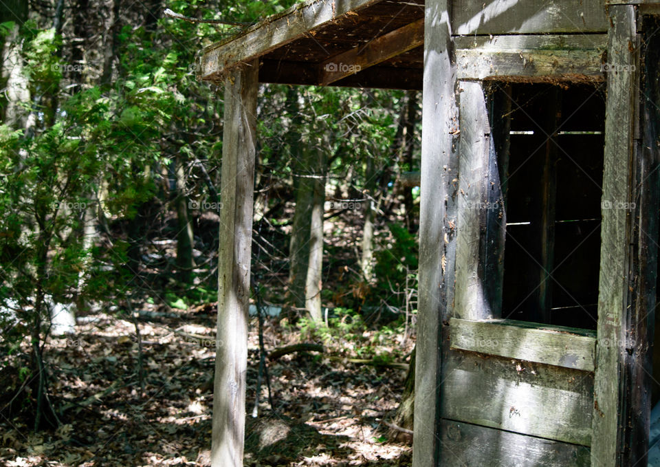 Edge of an old wood shed cabin abandoned in woods deteriorating abstract nostalgia and vintage country life background photography