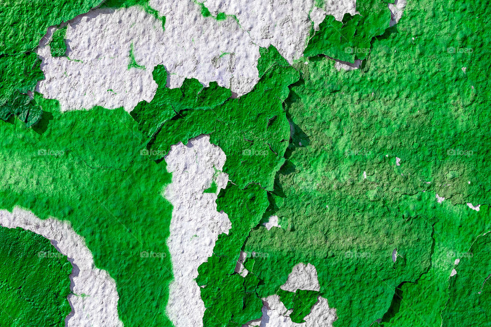 An old wall with green paint coming off, abstract background