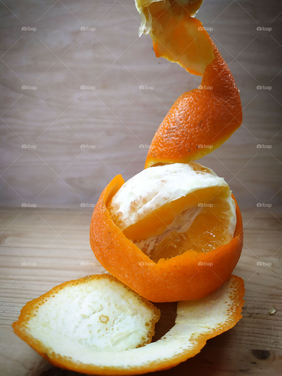 Peeled orange and orange zest in the form of a spiral
