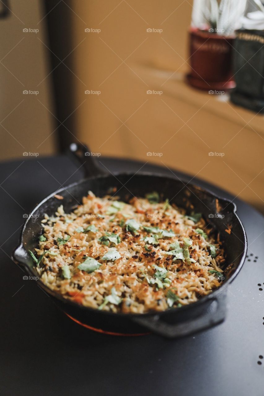 A scrumptious orzo morning pasta complete with chicken sausage, garlic, tomatoes, spinach, parsley, and mozzarella, topped with a crispy parmesan breadcrumb crust. Broiled in the oven in a cast iron pan for added taste. 