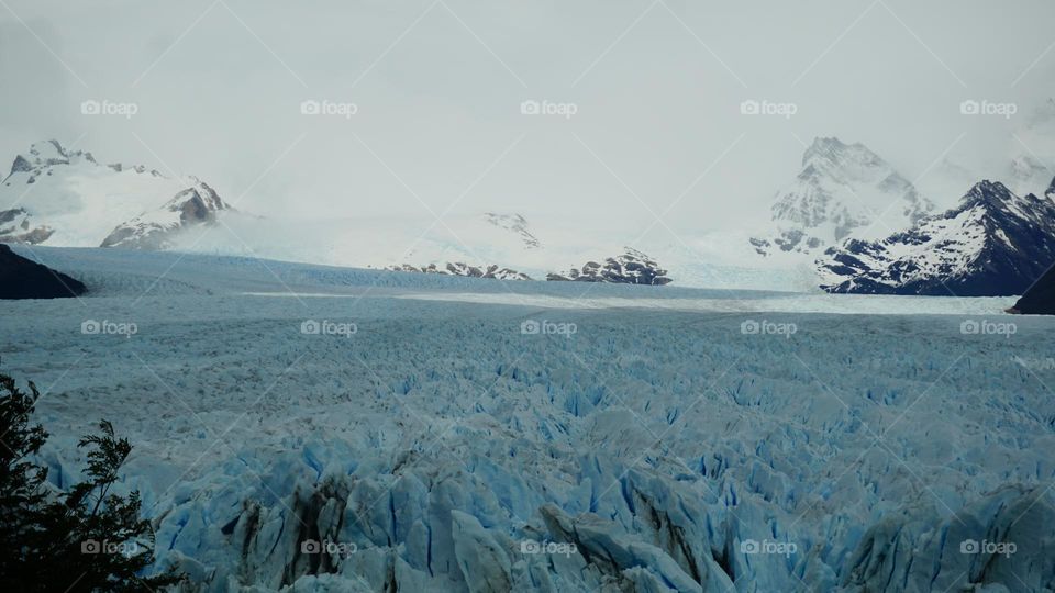 Large South American glacier amongst snowy landscape