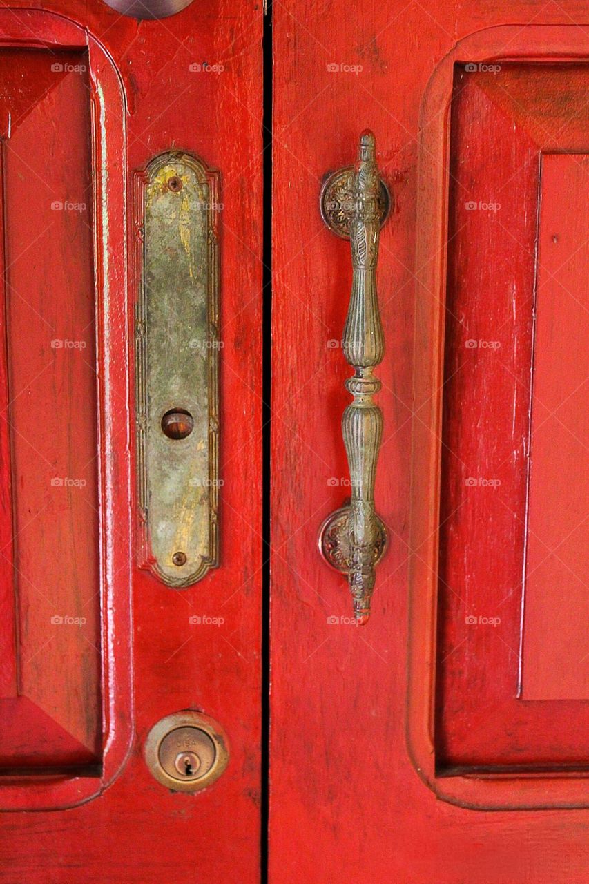 Red door with muted iron handles 