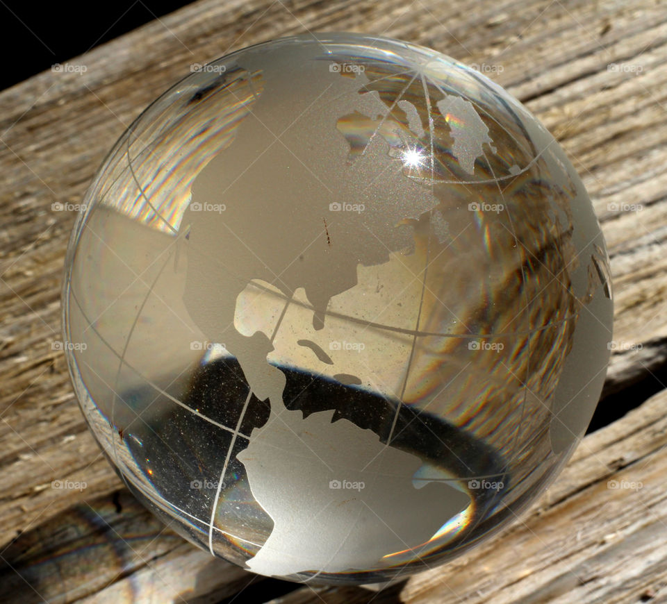 Glass earth globe on wood