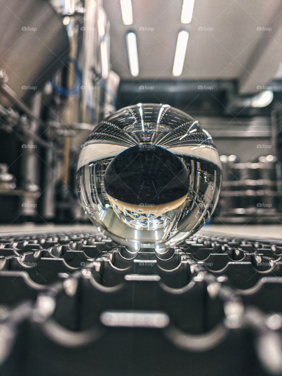 Beautiful reflection of the glass of beer in my lensball at the brewery close up.