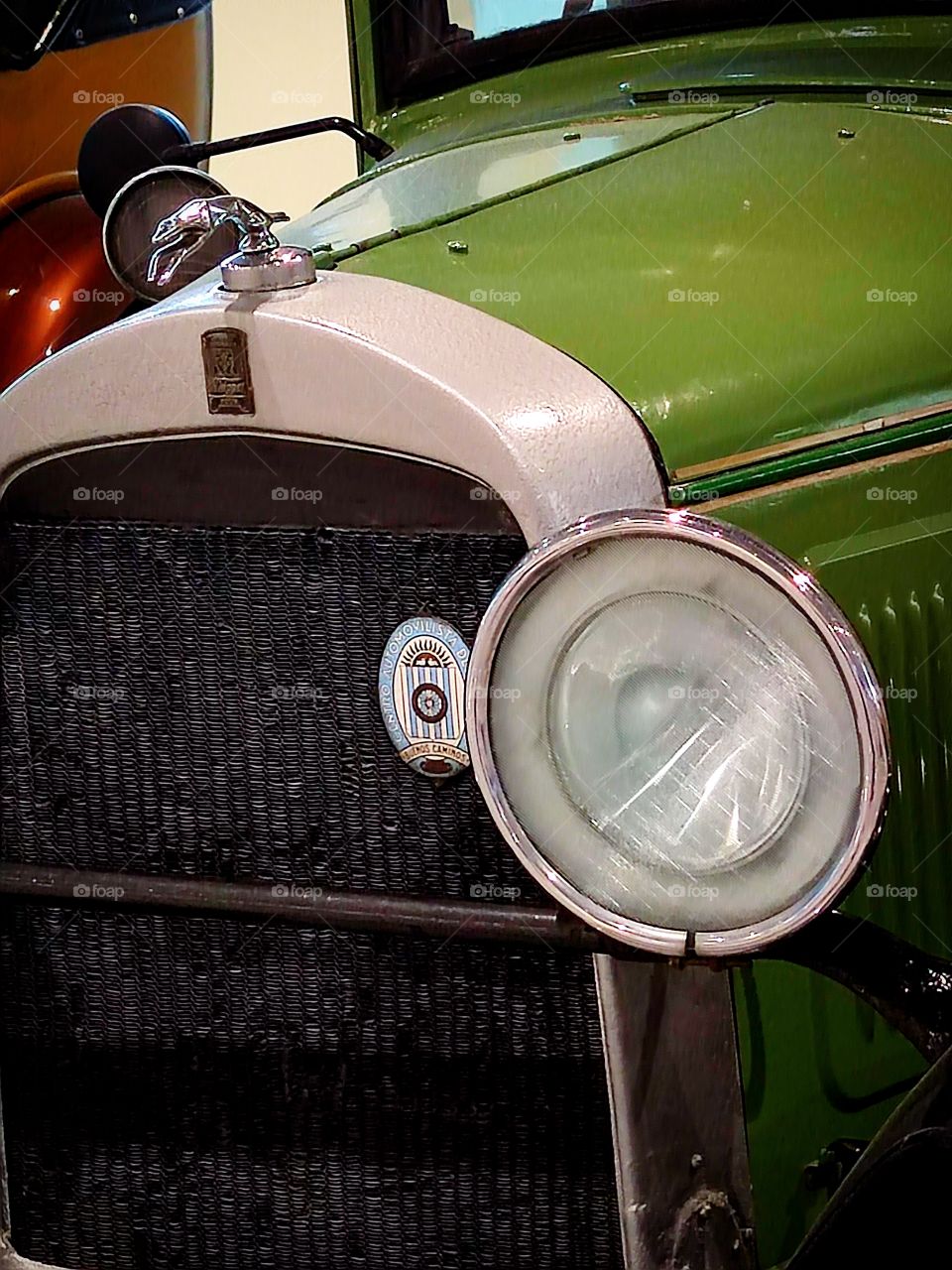 Green car.  "Willys Overland 96 A".  USA. 1929 year of release.  Close-up of the front with emblem and logos.  Retro cars