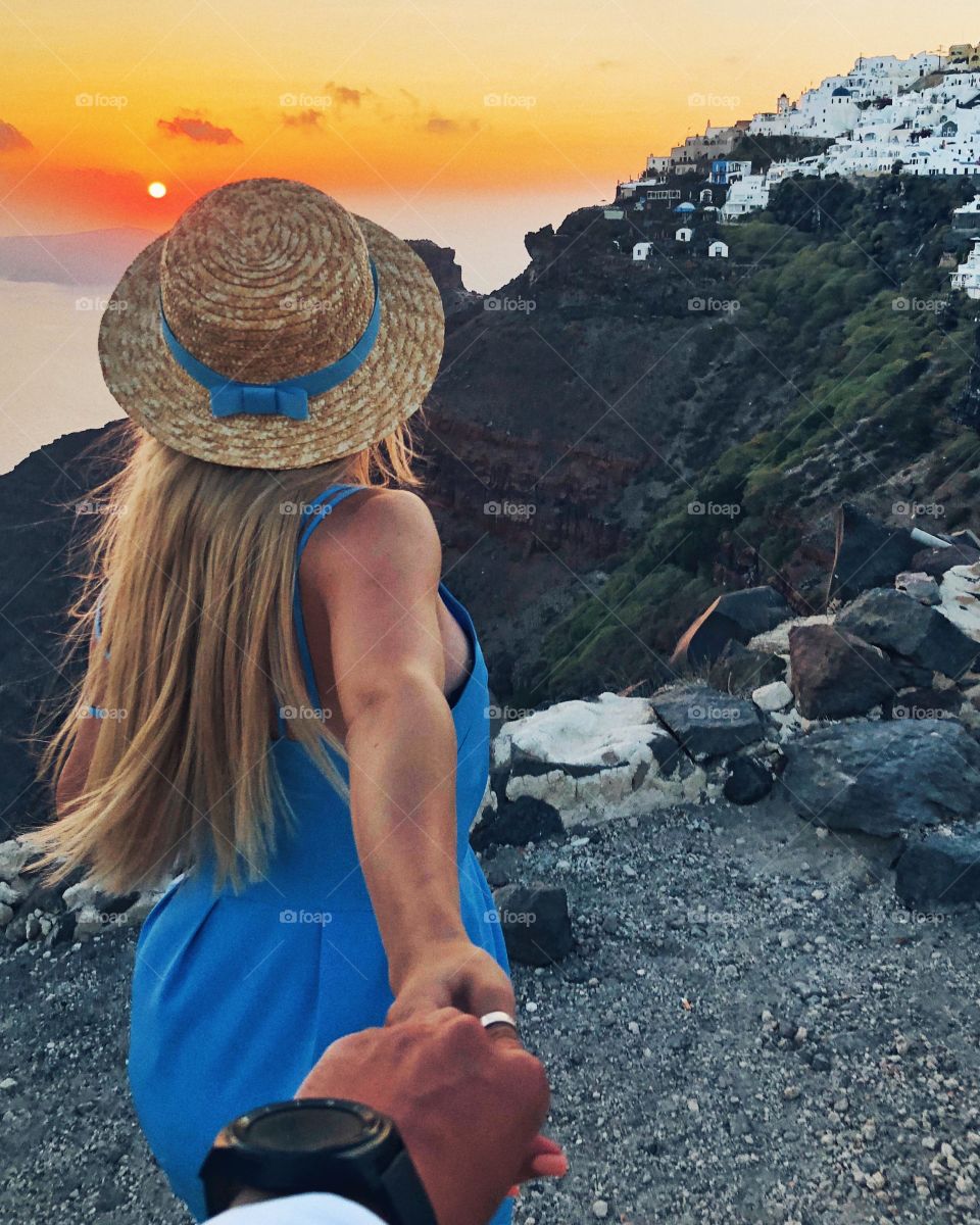 Follow me to Santorini. The guy and the girl are holding hands. Together forever.