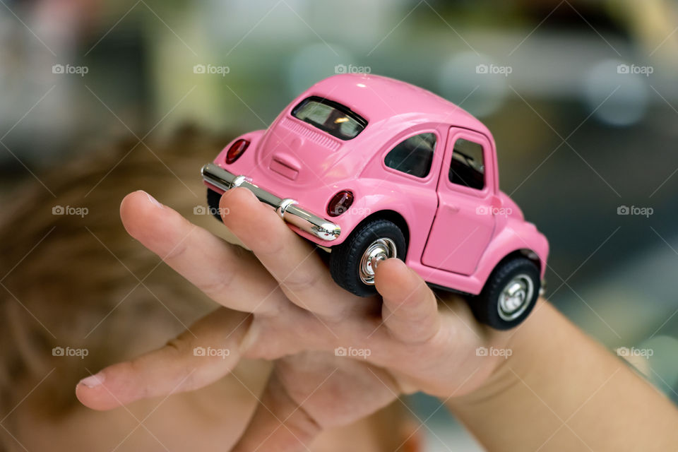 Odd numbers - car toy on a child hand